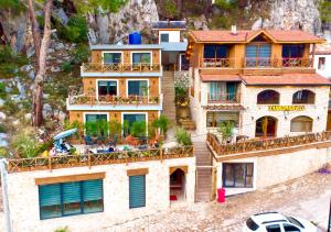 a building with people sitting on the balconies of it at Villa Taş Konak in Gedeller