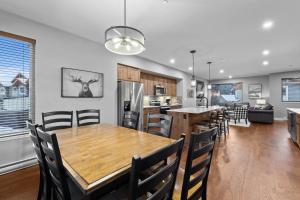 a dining room and kitchen with a table and chairs at Echo Landing #42 by Bear Country in Sun Peaks