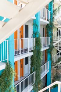 an apartment building with plants growing on the balconies at The Clarendon Hotel and Spa in Phoenix