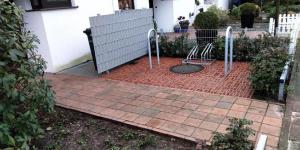 a red brick patio with a metal detector on it at Herzmuschel in Döse