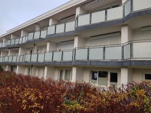 an apartment building with balconies on the side of it at Haus Kehrwieder Fewo 03 in Cuxhaven
