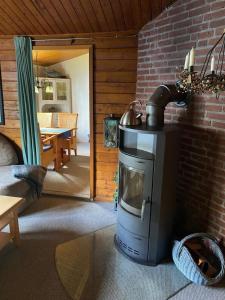 a living room with a stove in a room at Satelsrönne 02 in Duhnen