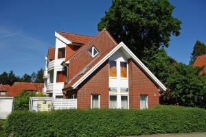 a red brick house with a white at Padua 4A in Duhnen