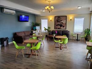 a living room with tables and chairs and a couch at Super 8 by Wyndham Duncan in Duncan