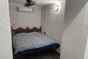 a small bedroom with a bed in a room at TMX HOSTAL in Puerto Escondido