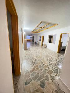 a hallway with a stone floor in a building at Hotel Don Blas Jardín in Jardin