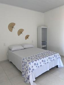 a bedroom with a bed with three umbrellas on the wall at BL Maria Bonita Pousada in Maragogi
