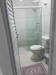 a bathroom with a toilet and a glass shower at BL Maria Bonita Pousada in Maragogi
