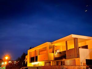 a large building at night with a street light at Dreamy Apartment by Lake Haider and Lake Reschen Uniting Luxury, Nature and Relaxation in San Valentino alla Muta