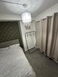 a bedroom with a bed and a chandelier at Gloucester in Gloucester
