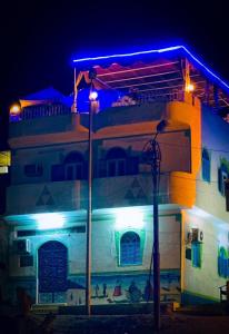 een gebouw met 's nachts blauwe lichten bij Gamal Robob Nubian Guest House in Aswan