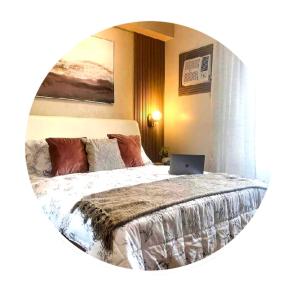 a bedroom with a bed with a laptop on it at Tehillah Residences in Bacolod +7 photos