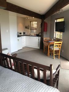 a room with a bed and a kitchen and a table at Bayview Studio in Diamond Harbour