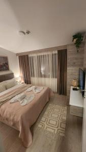 Ένα ή περισσότερα κρεβάτια σε δωμάτιο στο La Vie En Rose - Milmari Resort