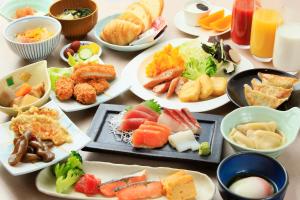 a table with many plates of food on it at Richmond Hotel Utsunomiya-ekimae in Utsunomiya