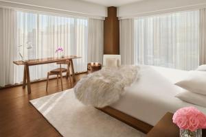a bedroom with a bed and a desk and a table at The Tokyo EDITION, Ginza in Tokyo
