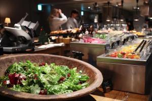 a buffet line with a salad in a bowl at THE KNOT TOKYO Shinjuku in Tokyo