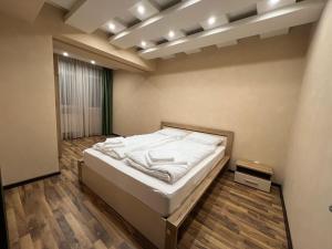 a bedroom with a bed in a room at Royal Brown Property in Oradea