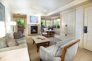 a living room with a couch and a fireplace at The Quail Lodge in Carmel