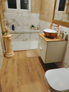 a bathroom with a sink and a tub and a toilet at Apartments Tatjana in Senj