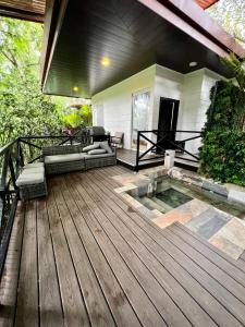 a patio with a pool on a wooden deck at Hotel Boutique Casa Del Rio in Fortuna