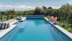 a swimming pool with inflatables in a backyard at Haumoana Herb Cottage in Haumoana