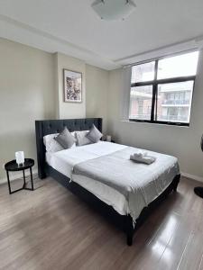 a bedroom with a large bed and a window at Entire 3 bed apartment in Ryde in Sydney