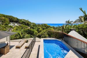 a swimming pool on a balcony with a view of the ocean at Moonrise & Starfall in Byron Bay