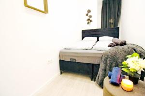 a bedroom with a bed and a table at Comfortable Rooms in AKH Area in Vienna