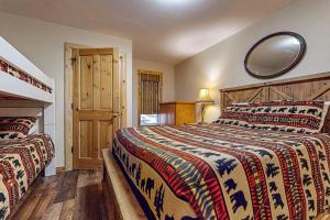 a bedroom with two beds and a mirror on the wall at Donner Escape in South Lake Tahoe