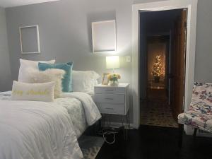 a bedroom with a bed and a night stand with a lamp at Peace of Cleveland 2bdrm Plus Semi Private Study with Futon 1st Floor Apartment Pets Welcomed, Family Friendly in Cleveland