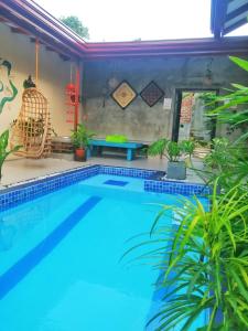 a swimming pool in a house with plants at Villa Aroma, Katunayaka in Minuwangoda