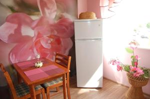 a dining room with a table and a refrigerator at Kate Sea Apartment in Pärnu