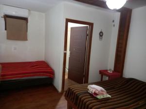 a bedroom with a bed and a door to a room at TOnat Caribe Hostel01 in West End
