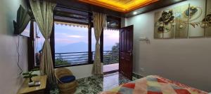 a bedroom with a large window with a view at Morning Mist Homestay in Gangtok
