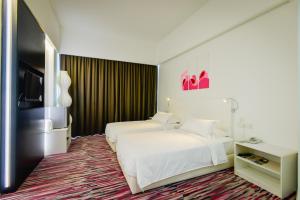 Postel nebo postele na pokoji v ubytování Pegasus Hotel Shah Alam