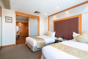 Voodi või voodid majutusasutuse Yihe Hotel Ouzhuang toas