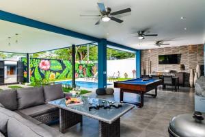 a living room with a pool table at Casa Emma - Oasis Playa Potrero in Playa Flamingo