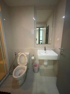 a bathroom with a toilet and a sink at The Base Pattaya by Feng in Pattaya Central +51 photos