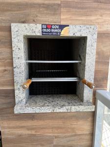 a brick oven with two metal racks in it at Apto Praia de Palmas in Governador Celso Ramos +80 photos
