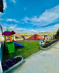 a park with a playground with a slide and play equipment at Nathy Villa in Khu Chi Lăng
