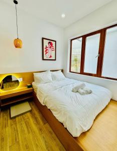 a bedroom with a large bed and a fireplace at Nathy Villa in Khu Chi Lăng