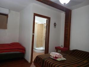 a bedroom with a bed and a door to a bathroom at TOnat Caribe Hostel01 in West End