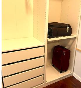 a closet with a suitcase and a suitcase at Lovely comfy home private bath in central Calgary in Calgary