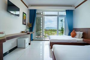 a hotel room with two beds and a balcony at Kampot View Boutique in Kampot