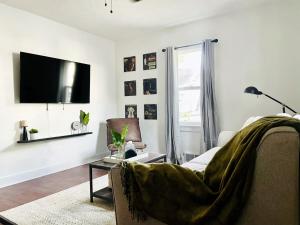 a living room with a couch and a tv at Centrally Located EVV Apartments in Evansville