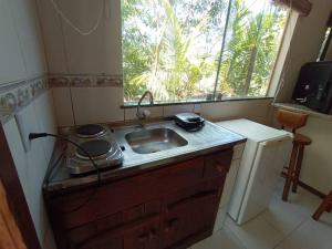 a small kitchen with a sink and a window at Suite 1 in Marau