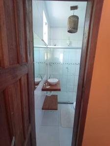 a white bathroom with two sinks and a toilet at Suite 1 in Marau