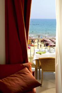 uma mesa com vista para a praia através de uma janela em Apartment in Roseto Degli Abruzzi em Roseto degli Abruzzi
