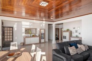 a living room with a couch and a wooden ceiling at Casa Coelho in Ponta do Sol